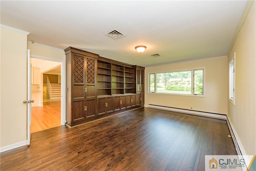 565 Foothill Road Bridgewater, NJ 08807 - Photo 7 of 25 an empty room with wooden floor and windows