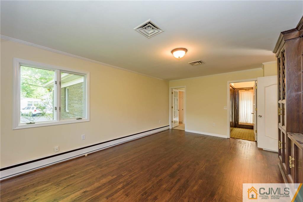 565 Foothill Road Bridgewater, NJ 08807 - Photo 8 of 25 a view of an empty room with wooden floor and a window