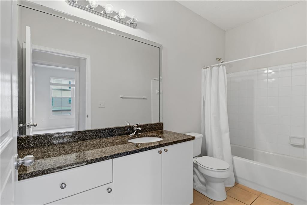 10 Perimeter Summit Boulevard, Unit 3311 Atlanta, GA 30319 - Photo 68 of 68 a bathroom with a granite countertop sink a toilet and shower