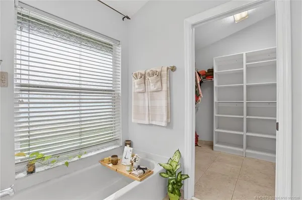 a view of walk in closet with clothes