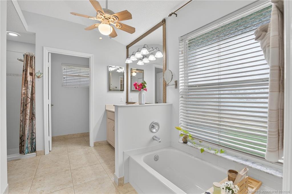 9275 Southeast Mercury Street Hobe Sound, FL 33455 - Photo 14 of 65 a bathroom with a bathtub and a sink