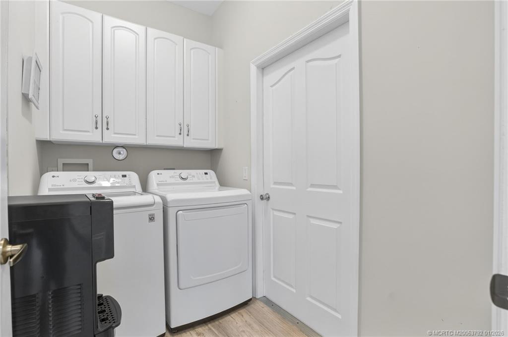 9275 Southeast Mercury Street Hobe Sound, FL 33455 - Photo 16 of 65 a utility room with dryer and washer