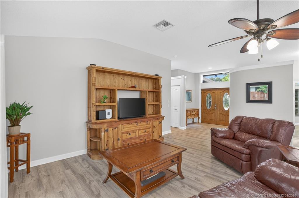 9275 Southeast Mercury Street Hobe Sound, FL 33455 - Photo 20 of 65 a living room with furniture and a flat screen tv