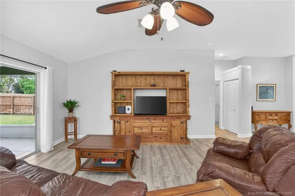 a kitchen with stainless steel appliances granite countertop a stove top oven a sink dishwasher a dining table and chairs with wooden floor