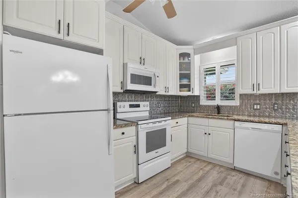 a bathroom with a granite countertop toilet sink and shower