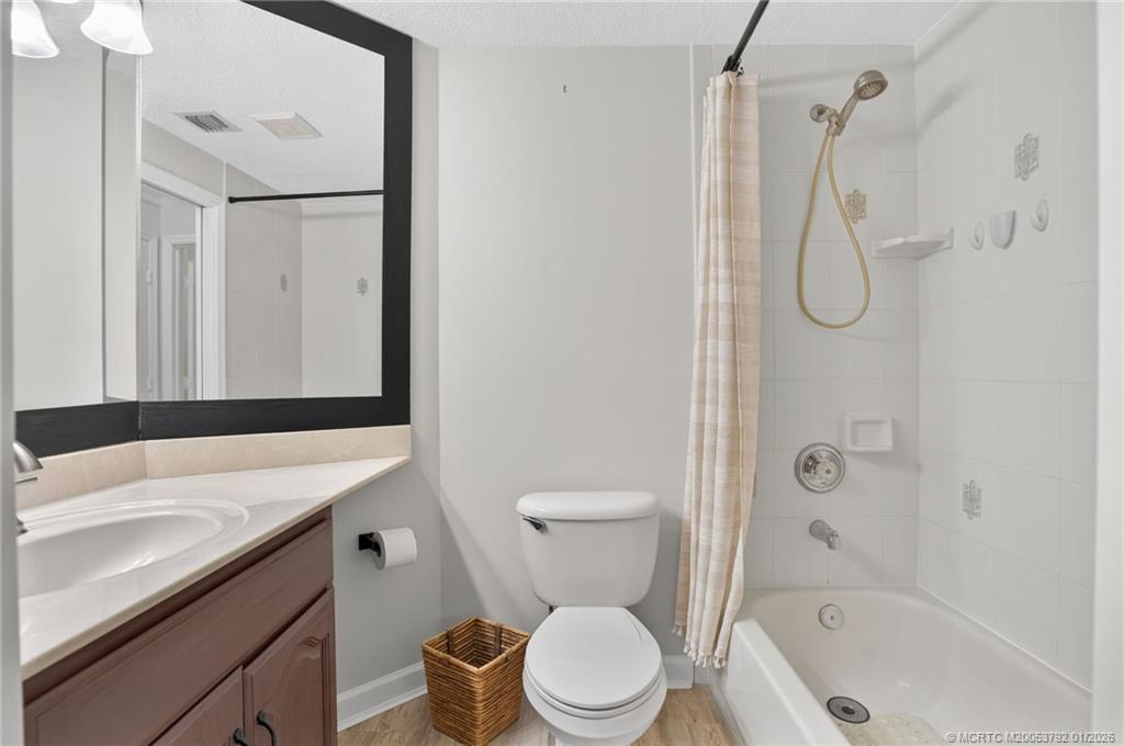 9275 Southeast Mercury Street Hobe Sound, FL 33455 - Photo 33 of 65 a bathroom with a granite countertop toilet sink and shower