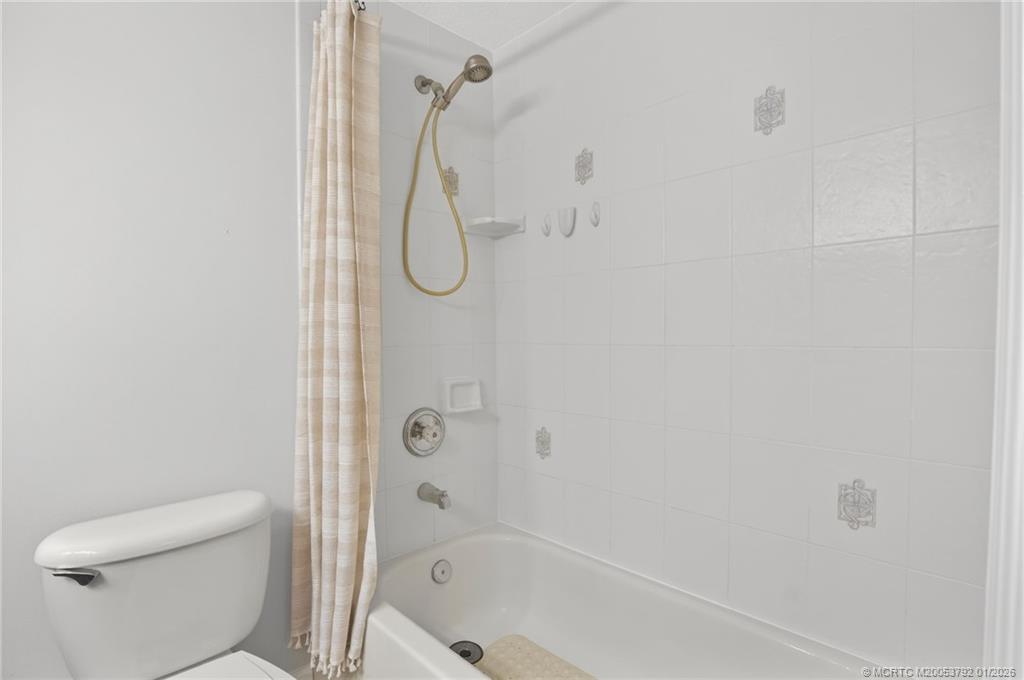 9275 Southeast Mercury Street Hobe Sound, FL 33455 - Photo 34 of 65 a bathroom with a shower a toilet and a shower