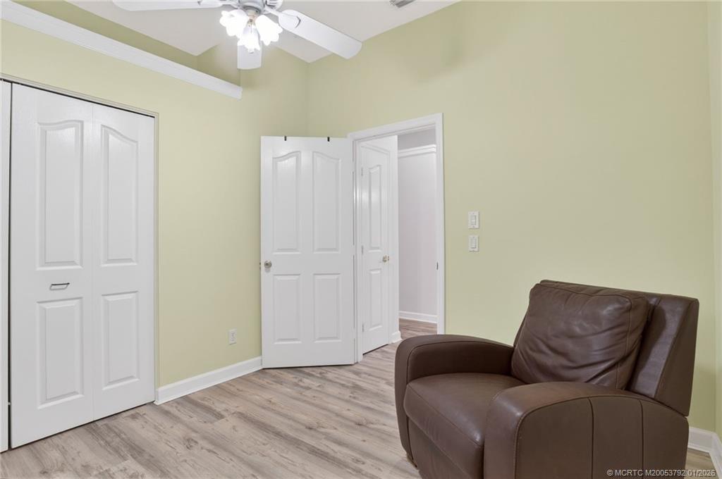 9275 Southeast Mercury Street Hobe Sound, FL 33455 - Photo 36 of 65 a living room with furniture and a chandelier