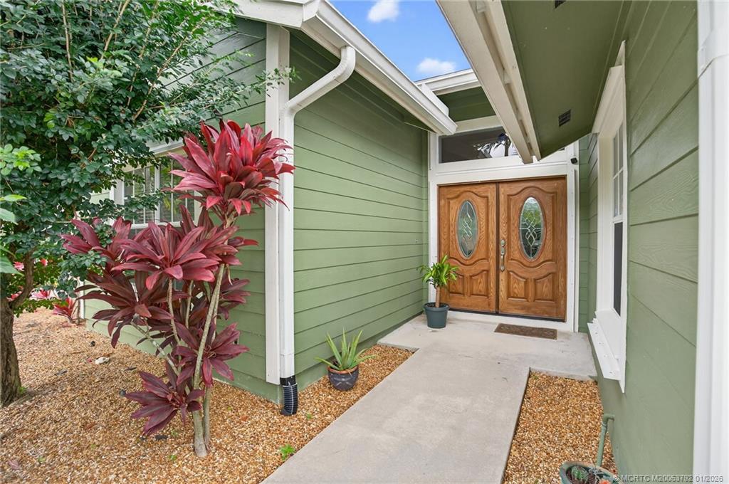 9275 Southeast Mercury Street Hobe Sound, FL 33455 - Photo 4 of 65 a backyard of a house with potted plants