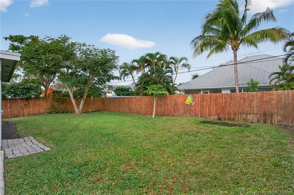 9275 Southeast Mercury Street Hobe Sound, FL 33455 - Photo 43 of 65 a view of a backyard with a garden