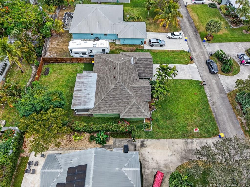 9275 Southeast Mercury Street Hobe Sound, FL 33455 - Photo 54 of 65 an aerial view of multiple houses with yard