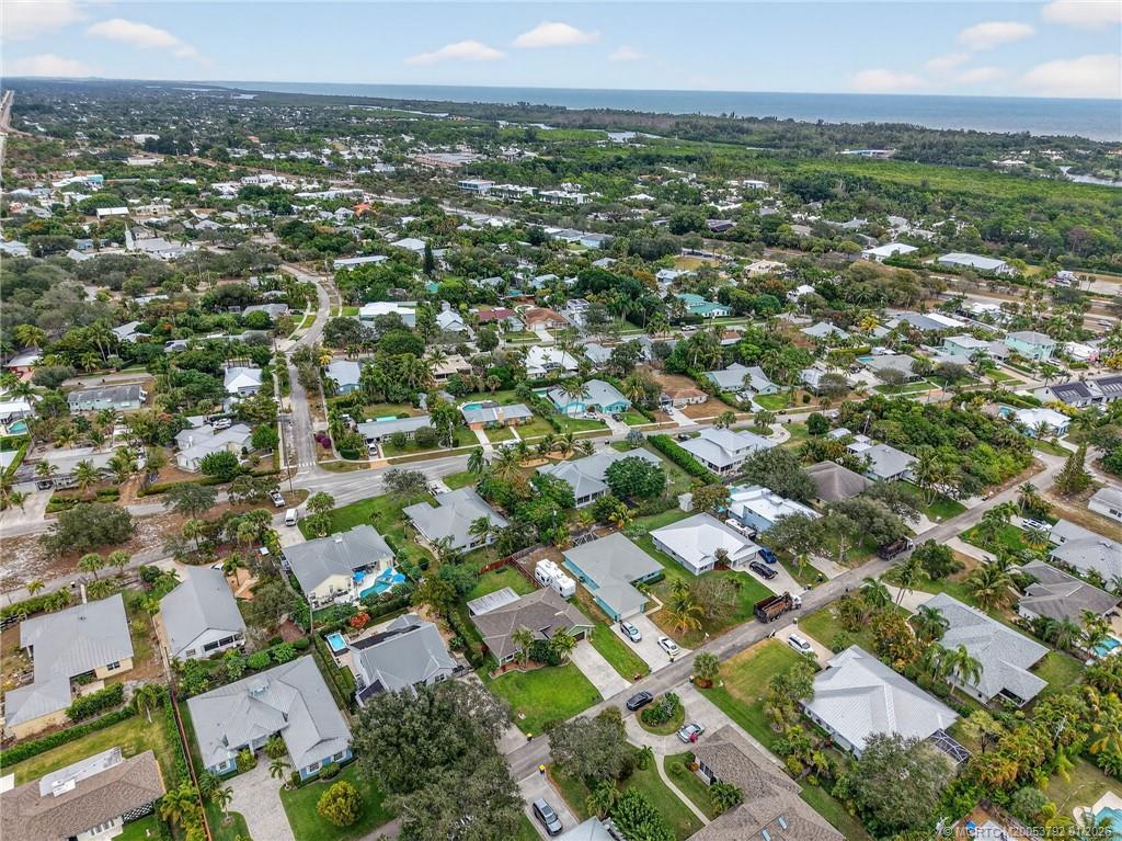 9275 Southeast Mercury Street Hobe Sound, FL 33455 - Photo 58 of 65 an aerial view of residential houses with outdoor space and trees