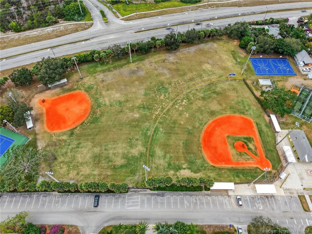 9275 Southeast Mercury Street Hobe Sound, FL 33455 - Photo 63 of 65 an aerial view of a house with swimming pool and large trees