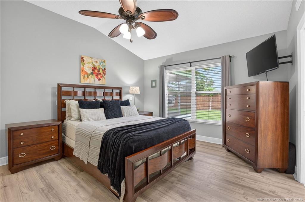 9275 Southeast Mercury Street Hobe Sound, FL 33455 - Photo 7 of 65 a bedroom with a bed and a flat screen tv