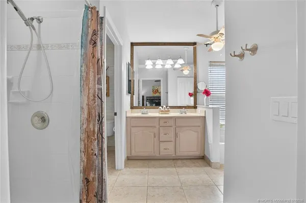 a bathroom with a sink a vanity a mirror a bathtub and a shower