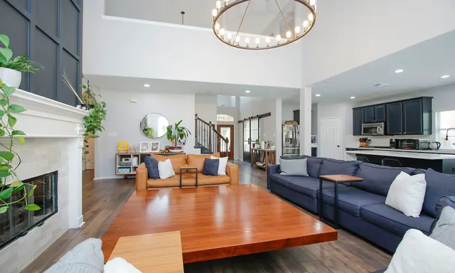a living room with fireplace furniture and a wooden floor