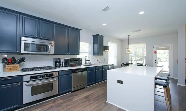a kitchen with wooden cabinets and stainless steel appliances