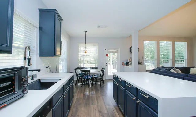 a open kitchen with stainless steel appliances granite countertop a sink stove and cabinets