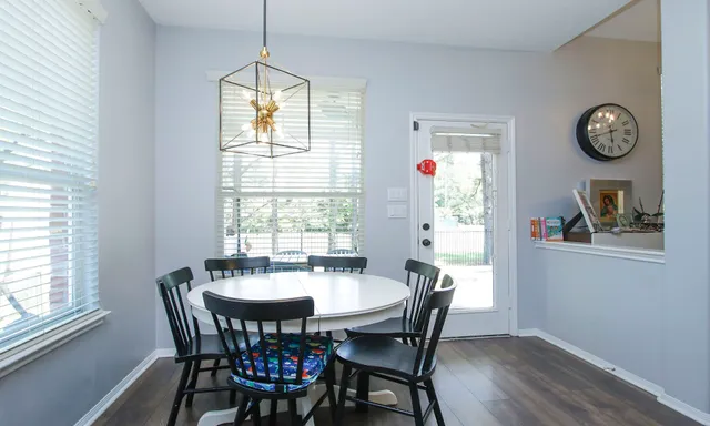 a dining room with furniture window and wooden floor