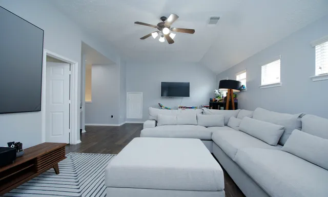 a living room with furniture and a flat screen tv