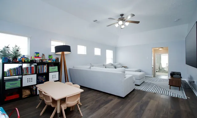 a living room with furniture and wooden floor