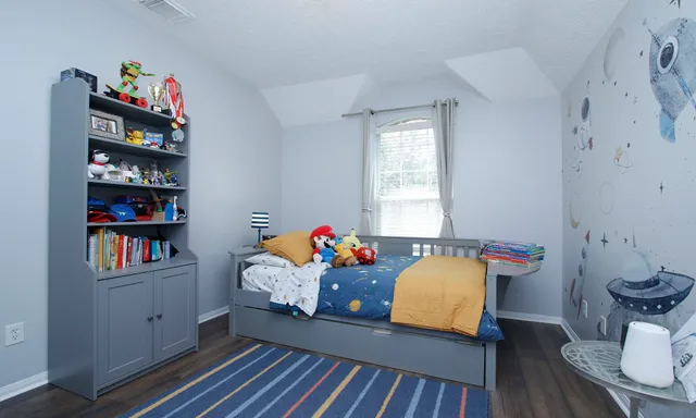 a living room with furniture toys and a book shelf