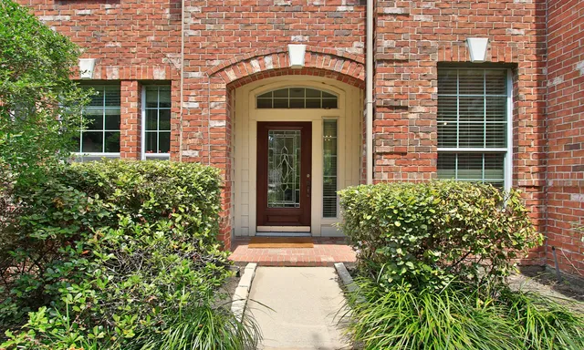 front view of a brick house with a large windows
