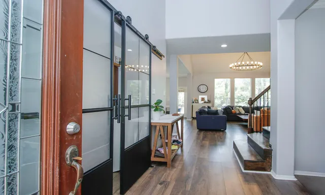 a living room with furniture and a wooden floor