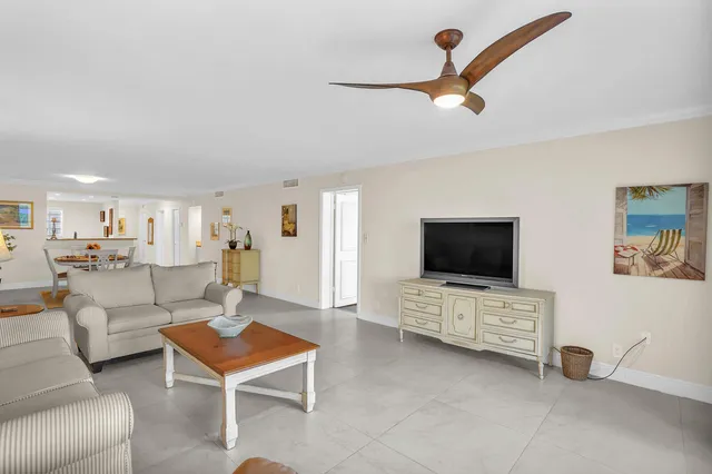 a spacious bedroom with a bed and a flat screen tv