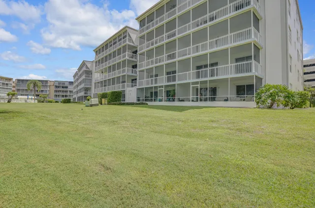 a view of a big yard with lots of green space