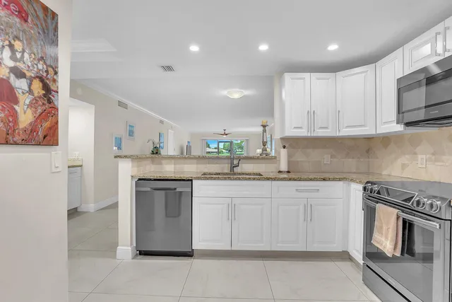 a view of a small space with wooden floor and a window