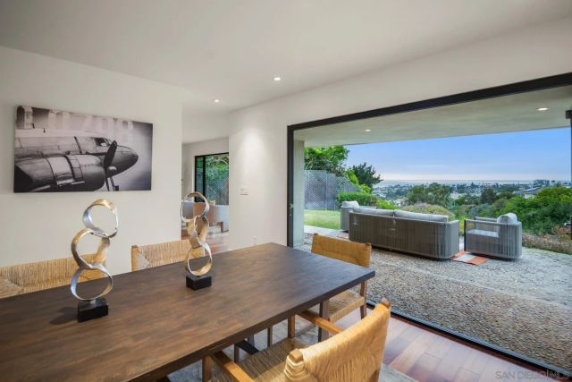 a view of a dining room with furniture window and garden view