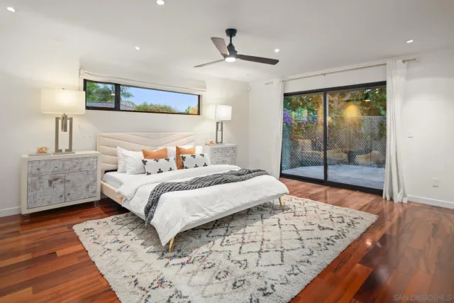 a bedroom with a bed and a night stand