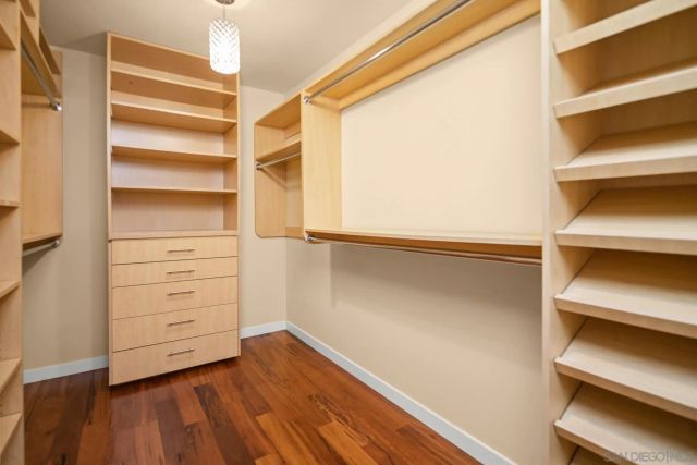 a view of walk in closet with empty racks