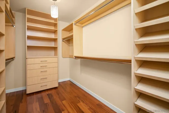 a view of walk in closet with empty racks