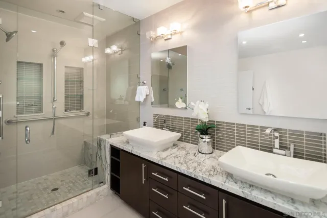 a bathroom with double sink and a mirror