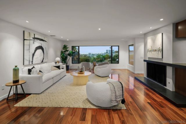 a living room with fireplace furniture and a wooden floor