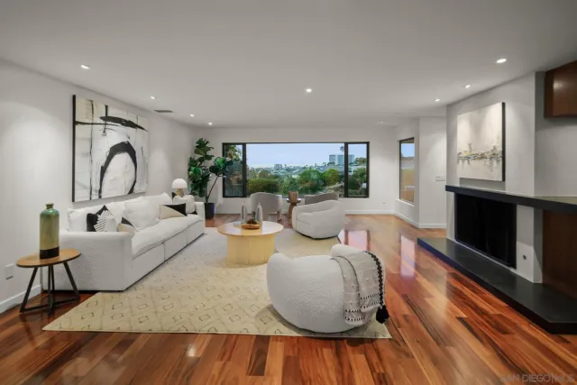 a living room with fireplace furniture and a wooden floor