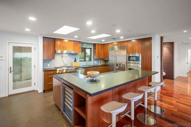 a kitchen with a table chairs and a refrigerator