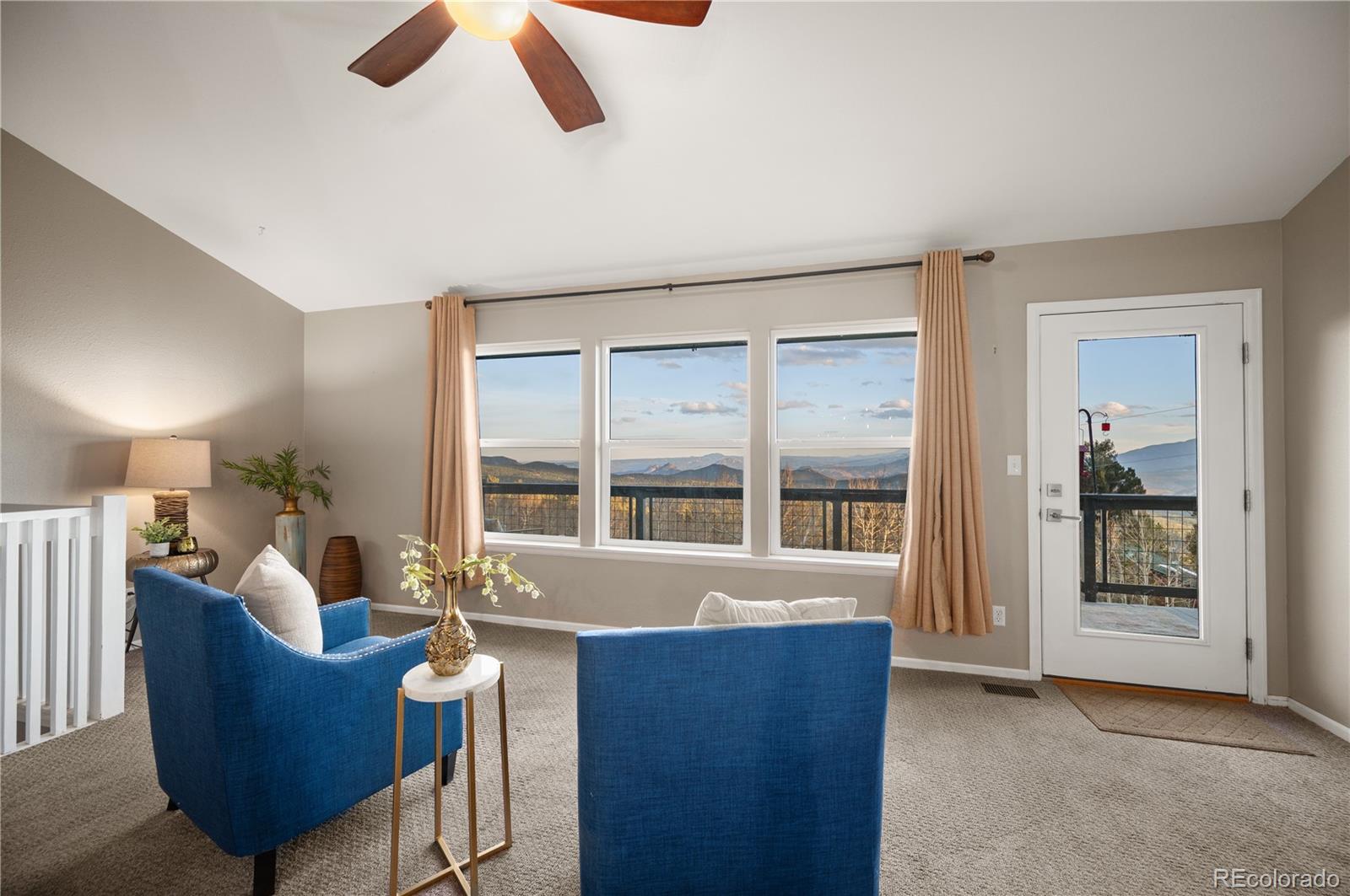 11740 Baca Road Conifer, CO 80433 - Photo 22 of 49 a living room with furniture and a large window