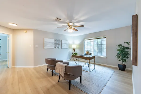 a living room with furniture and a wooden floor