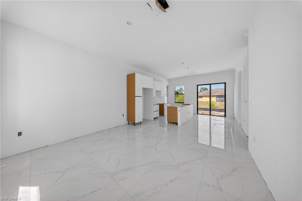 1213 Dodwin Street East Lehigh Acres, FL 33974 - Photo 12 of 28 wooden floor in an empty room with a window