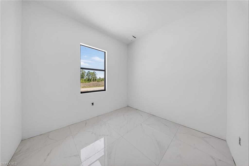 1213 Dodwin Street East Lehigh Acres, FL 33974 - Photo 14 of 28 an empty room with windows