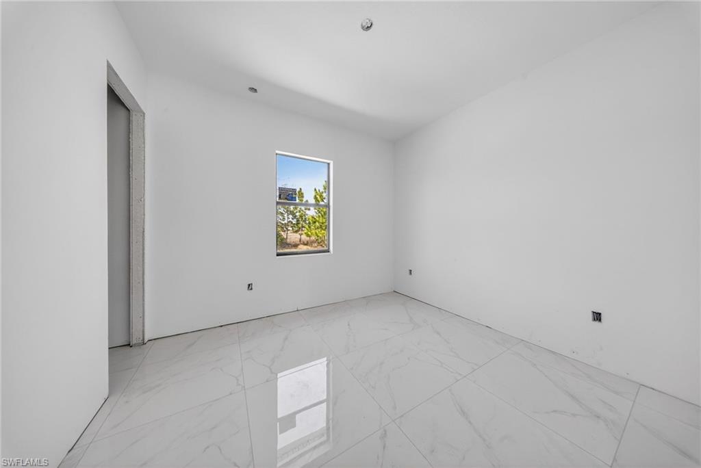 1213 Dodwin Street East Lehigh Acres, FL 33974 - Photo 16 of 28 a view of an empty room with a window