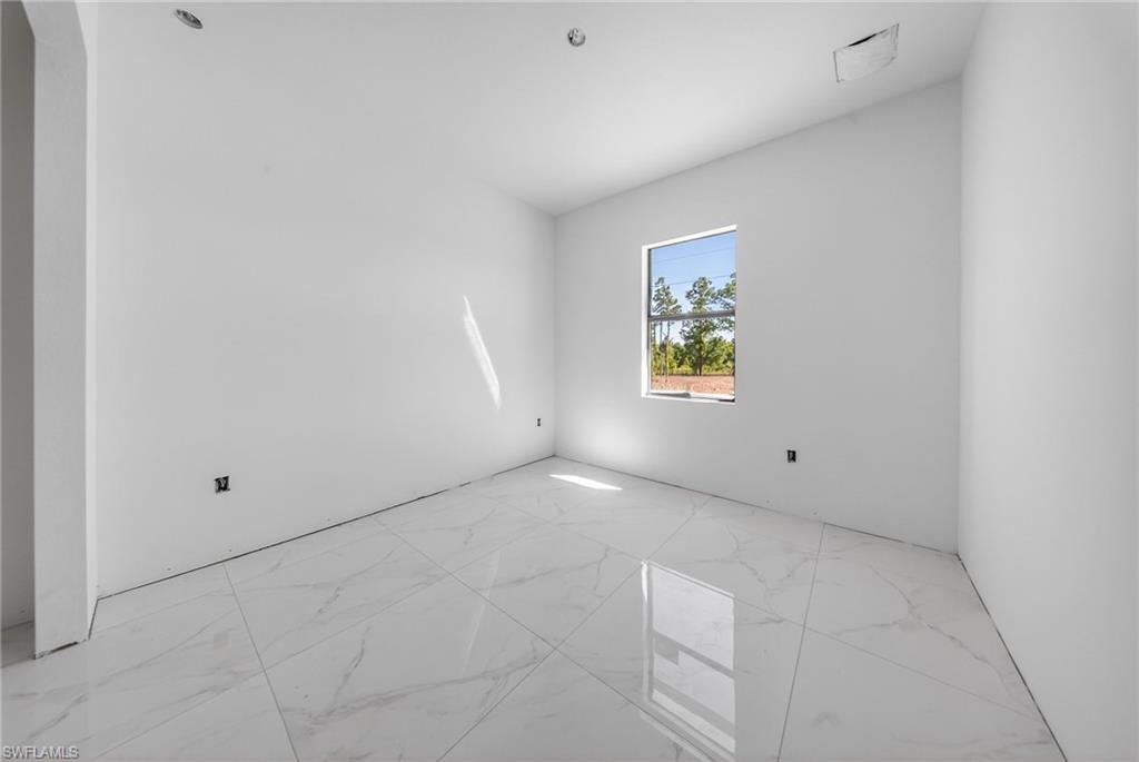 1213 Dodwin Street East Lehigh Acres, FL 33974 - Photo 17 of 28 a view of an empty room with a window