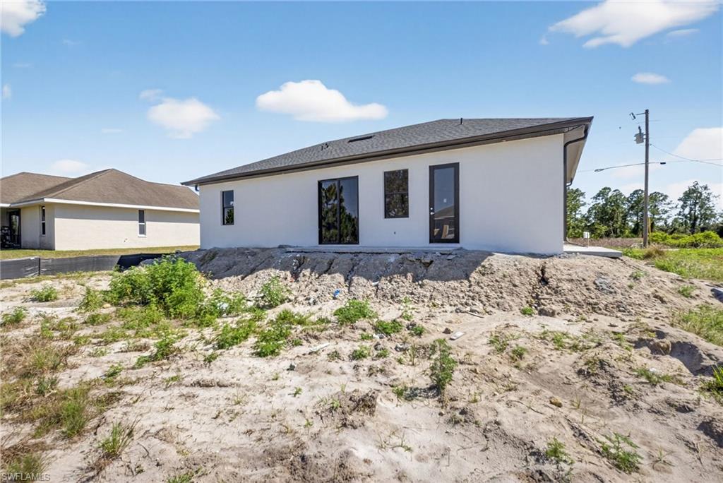 1213 Dodwin Street East Lehigh Acres, FL 33974 - Photo 21 of 28 a front view of a house with a yard