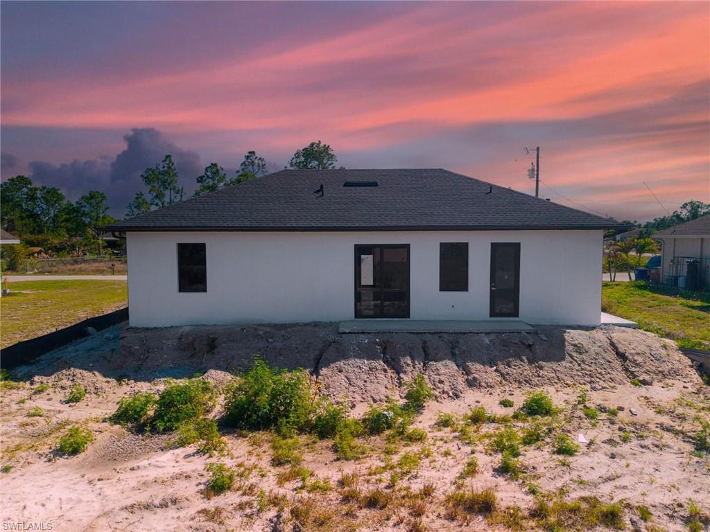 1213 Dodwin Street East Lehigh Acres, FL 33974 - Photo 22 of 28 a front view of a house with a yard