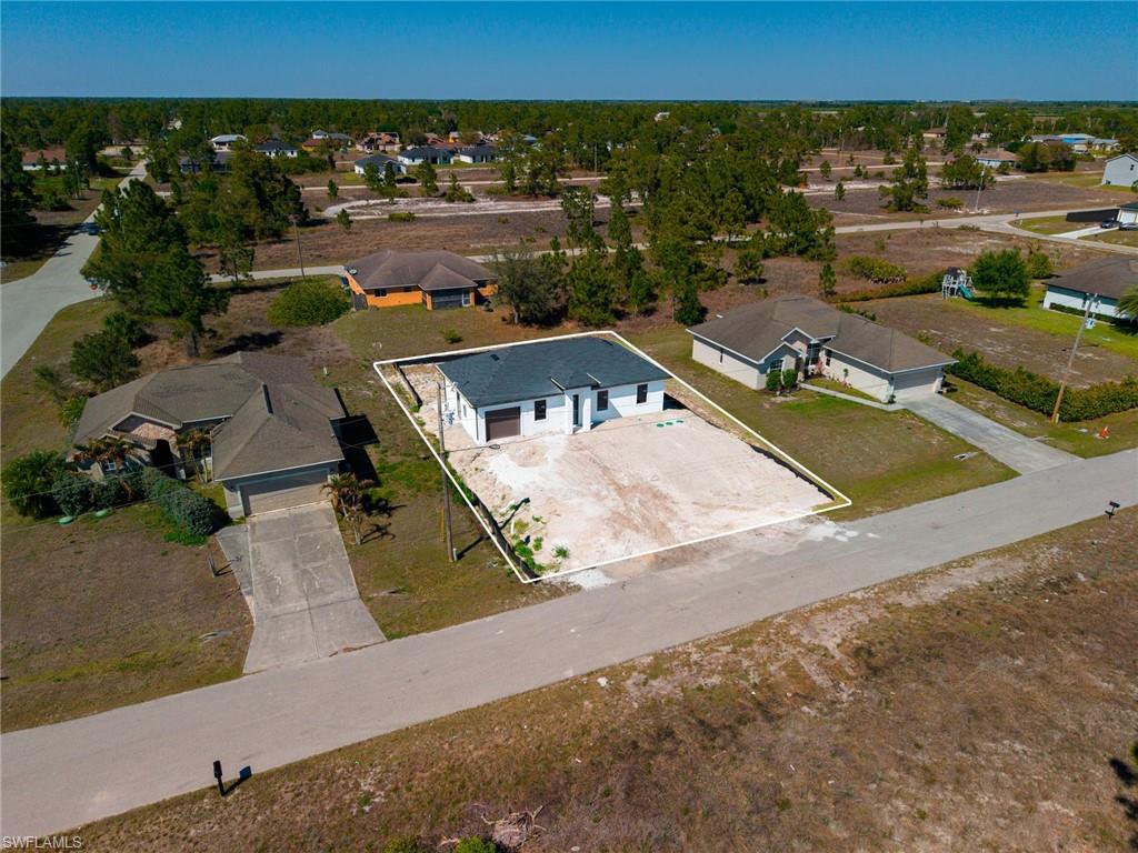 1213 Dodwin Street East Lehigh Acres, FL 33974 - Photo 26 of 28 an aerial view of a house with a swimming pool