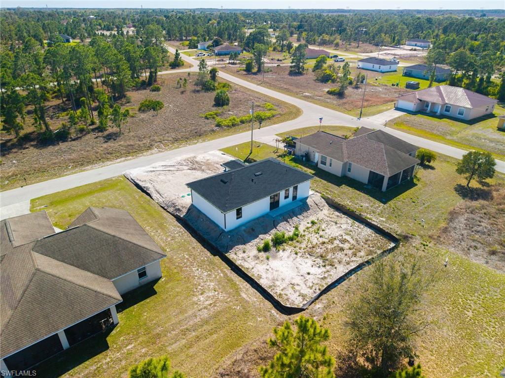 1213 Dodwin Street East Lehigh Acres, FL 33974 - Photo 27 of 28 an aerial view of a house with a swimming pool