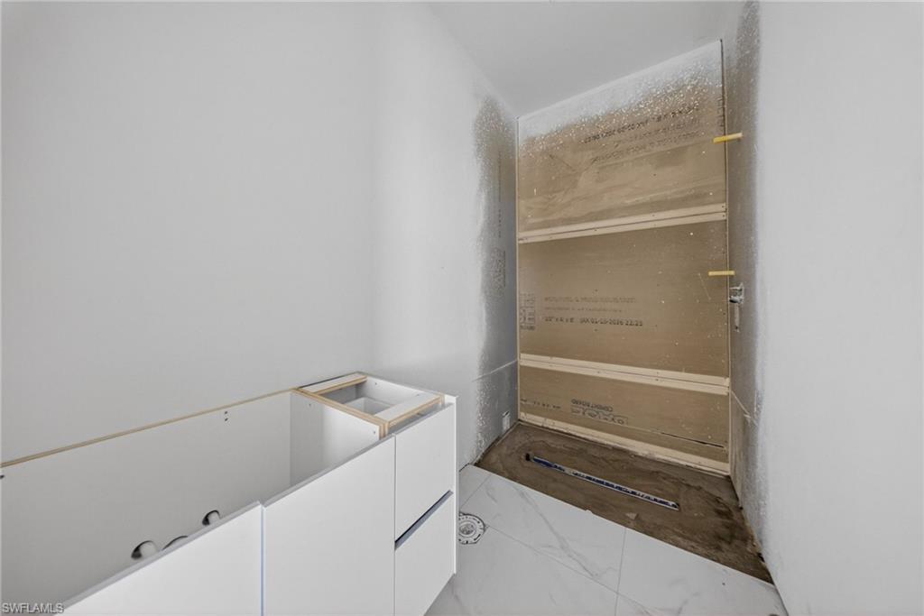 1213 Dodwin Street East Lehigh Acres, FL 33974 - Photo 5 of 28 a storage room with wooden floor